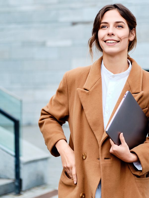 young-pretty-smiling-businesswoman-in-coat-with-2J3SG5G.jpg